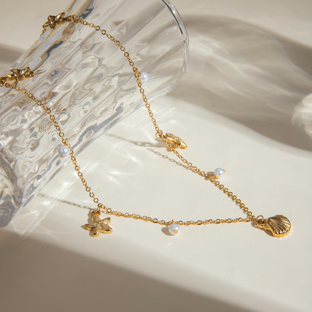 Dainty Seashell and Starfish Charm Necklace with Pearl Accents - Nuriale