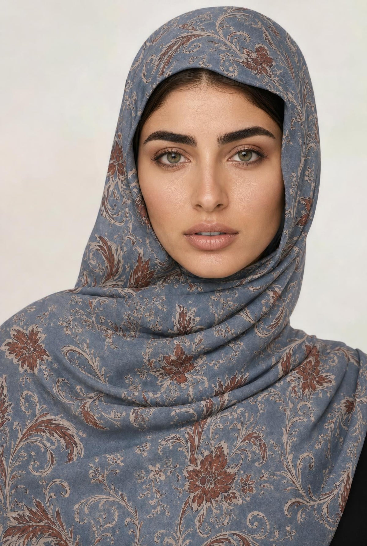 Zahira Modal Hijab worn, rust and cream scrollwork on slate blue